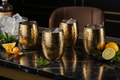 Hammered Gold Cocktail Glass Set on black marble bar